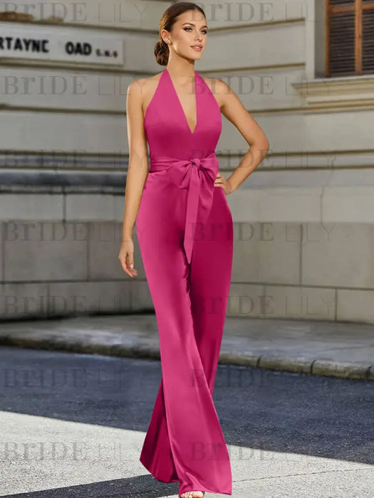 Satin halter jumpsuit with a bow belt in fuchsia