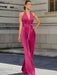 Satin halter jumpsuit with a bow belt in fuchsia