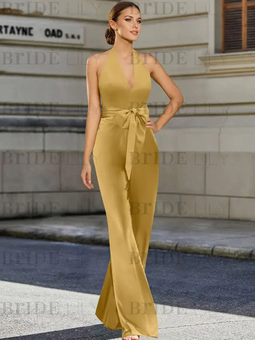Gold halter neck satin mother of the bride jumpsuit with bow belt