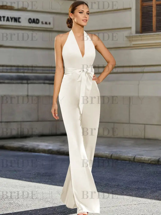 Satin halter jumpsuit with a bow belt in ivory
