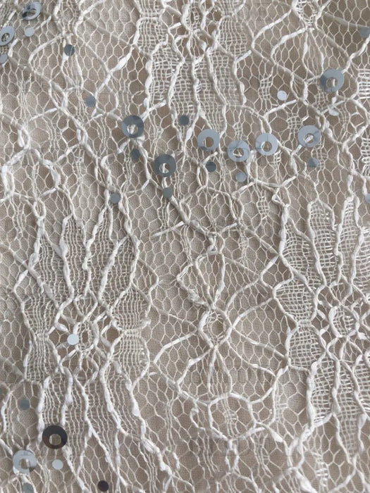 Close-up of the corded lace with scattered silver sequins