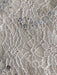 Close-up of the corded lace with scattered silver sequins