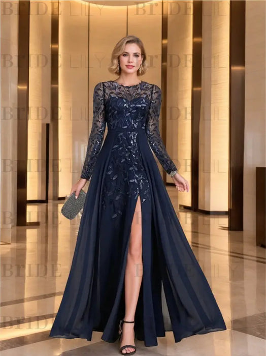 Navy sequin leaf chiffon gown with a front slit worn in a hotel lobby
