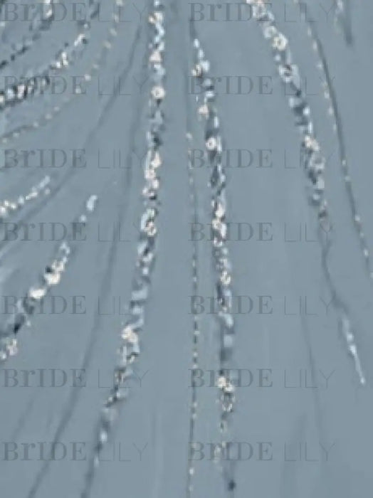Close-up of the sequin swirl embroidery on dusty blue chiffon
