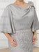 Close-up of the shoulder flower and draped satin top in silver grey