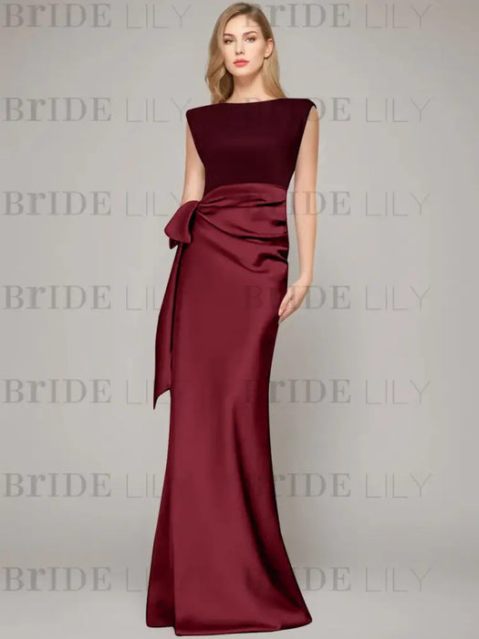 Sleeveless satin sheath gown with a ruched bow sash in burgundy
