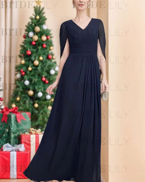 Navy chiffon cape sleeve gown worn indoors at Christmas