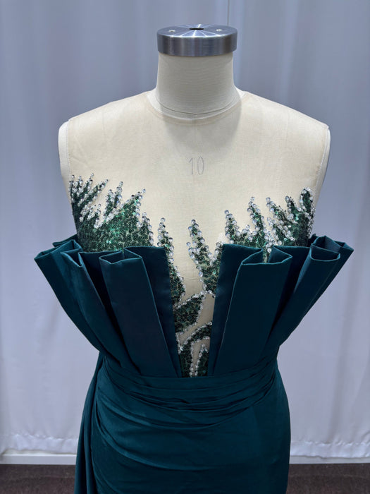 Teal dress with floral embellishments on a mannequin against a plain background