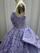 Purple evening gown with intricate lace details on a mannequin against a plain background
