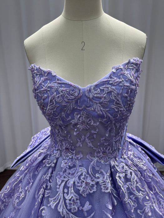 Purple lace dress on a mannequin against a neutral background