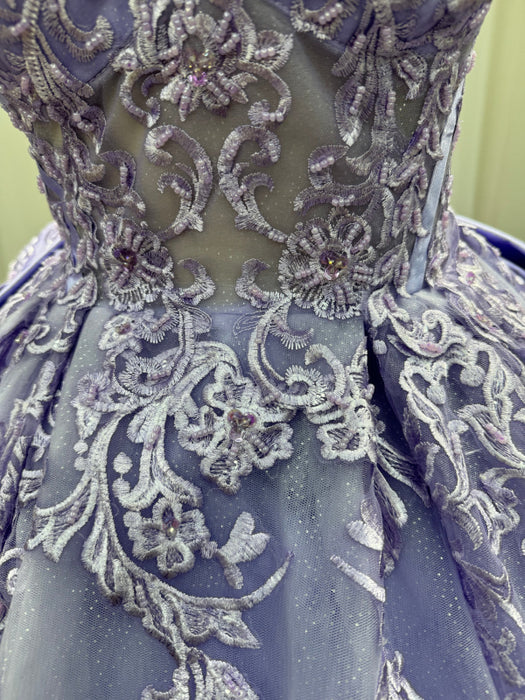 Close-up of a blue dress with intricate silver embroidery and embellishments.
