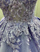 Close-up of a blue dress with intricate silver embroidery and embellishments.