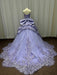 Lavender ball gown with intricate lace details on a mannequin against a plain background.